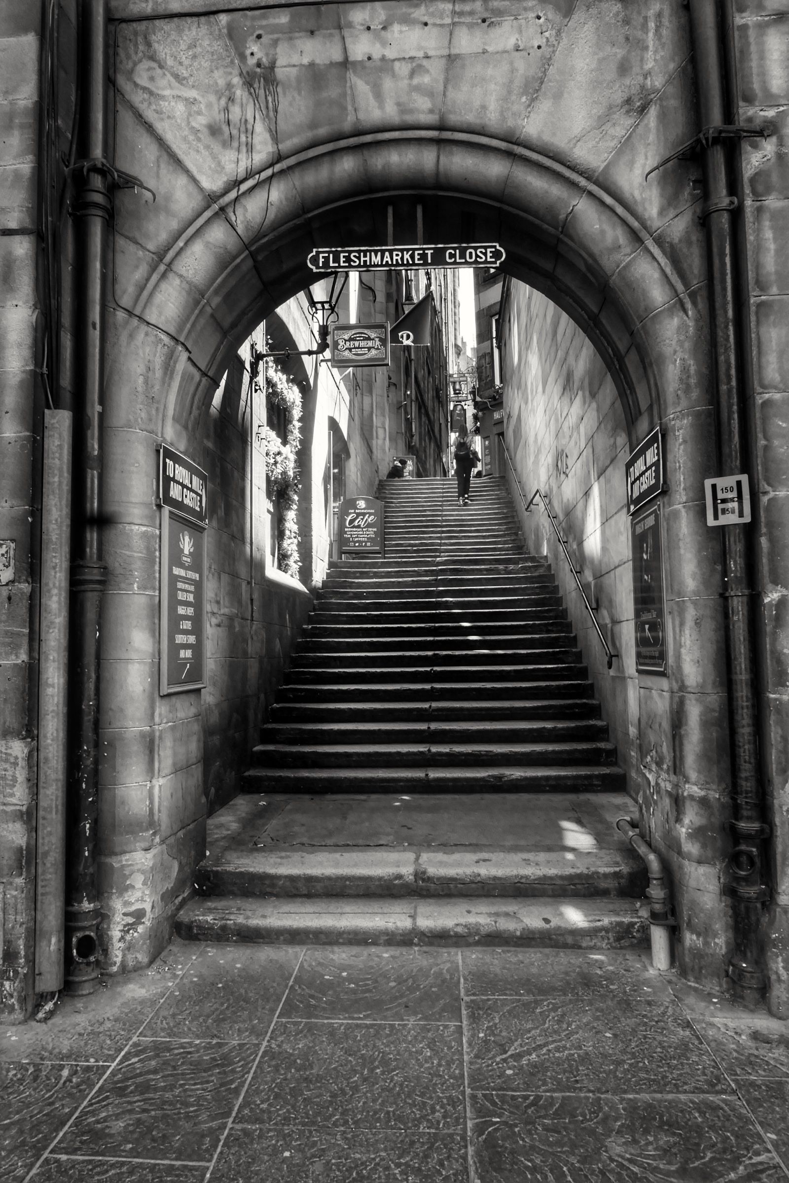 The stone arch onto Market Street from inside the close, in black and white