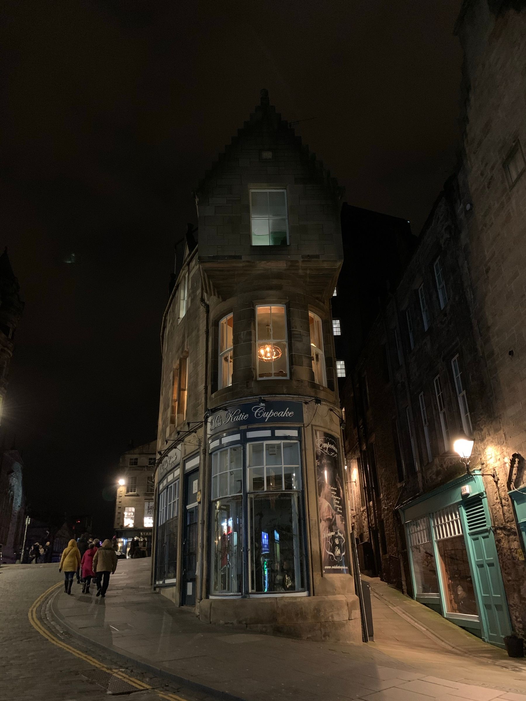 The corner of Fleshmarket Close and Cockburn Street at night, the turret building lit