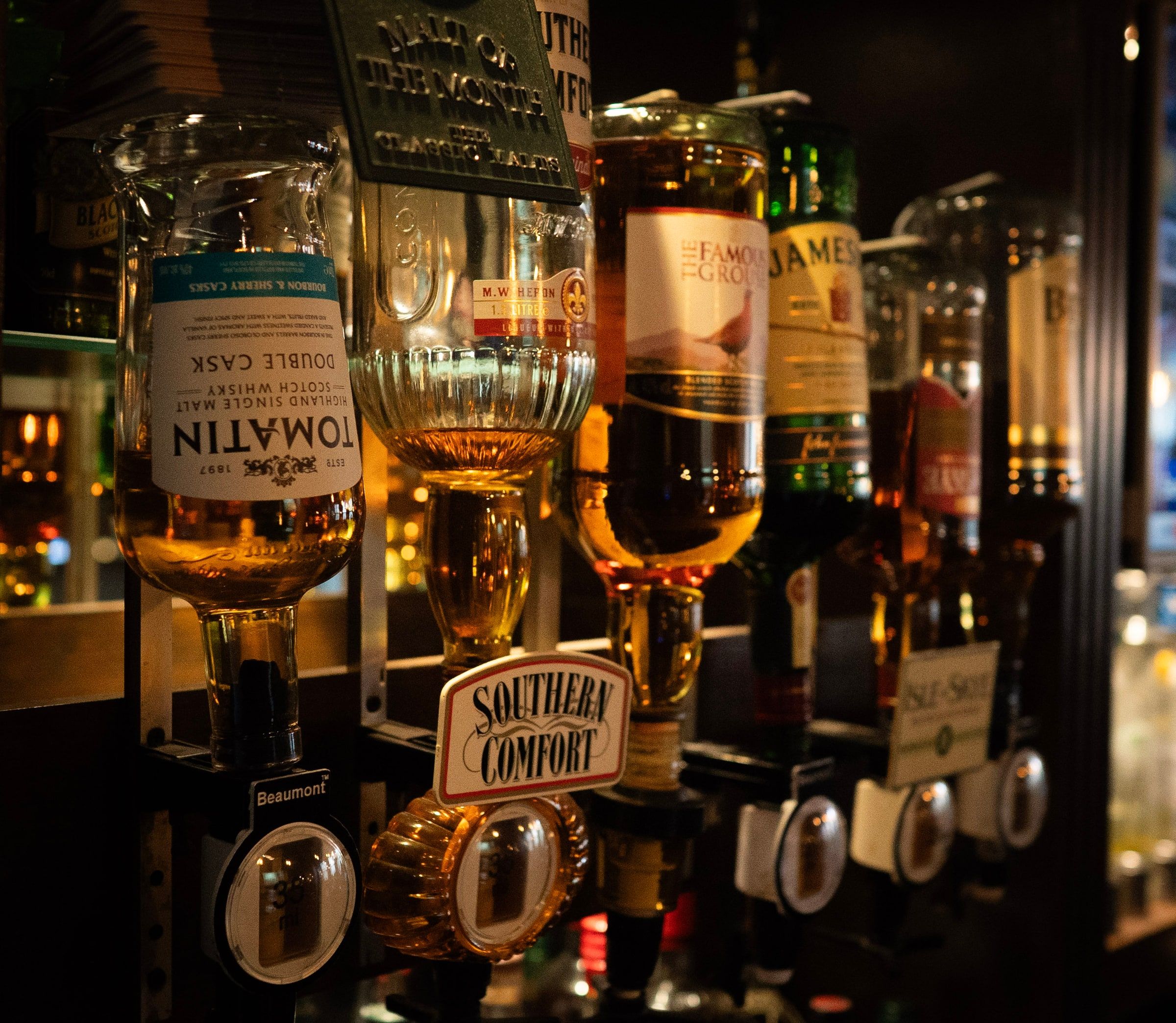 Upside down bottles on the optics, including Tomatin, Southern Comfort, Famous Grouse and Jameson