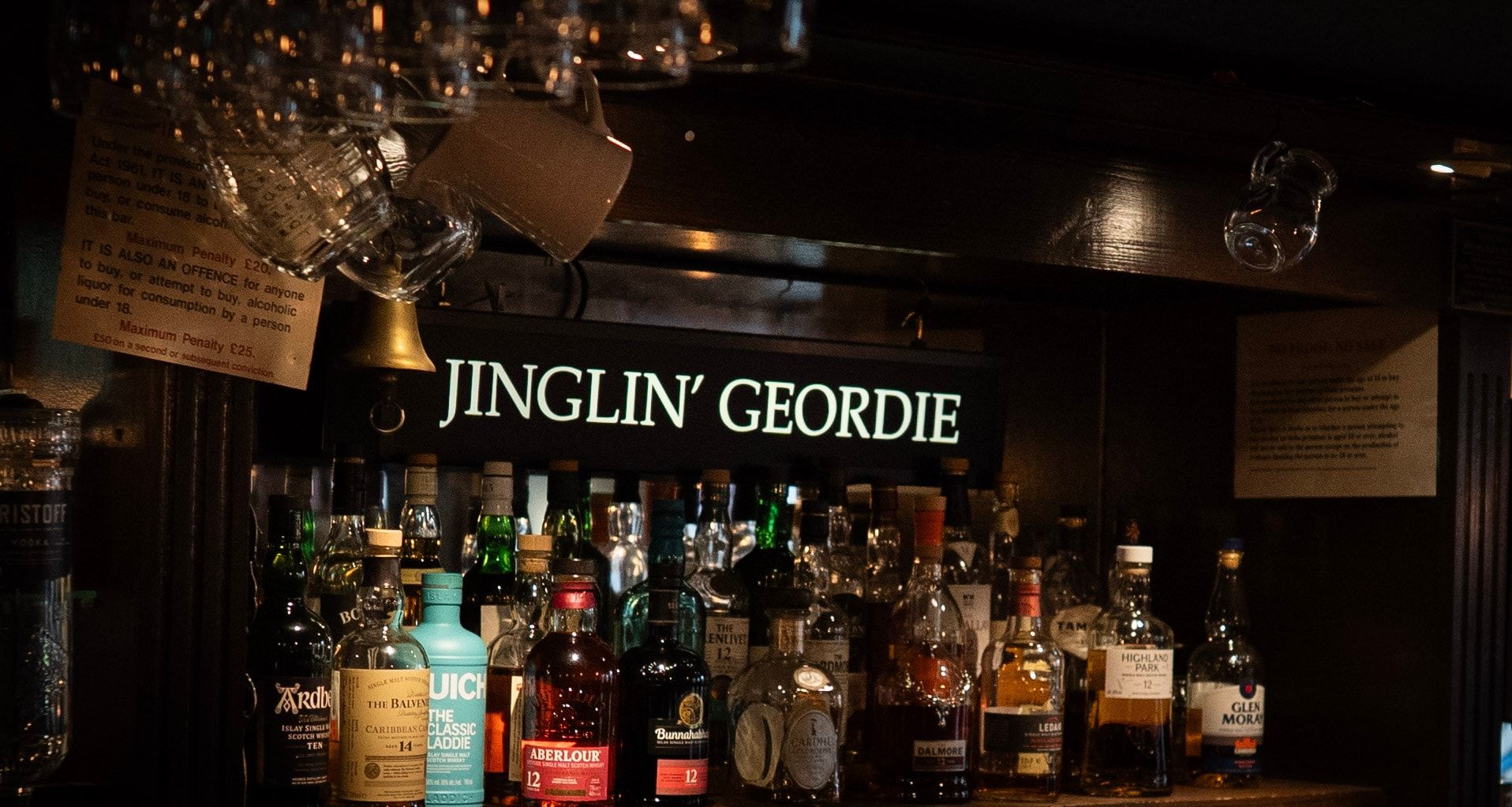 The bar, with the Jinglin’ Geordie sign above the gantry and the malts lined up beneath it