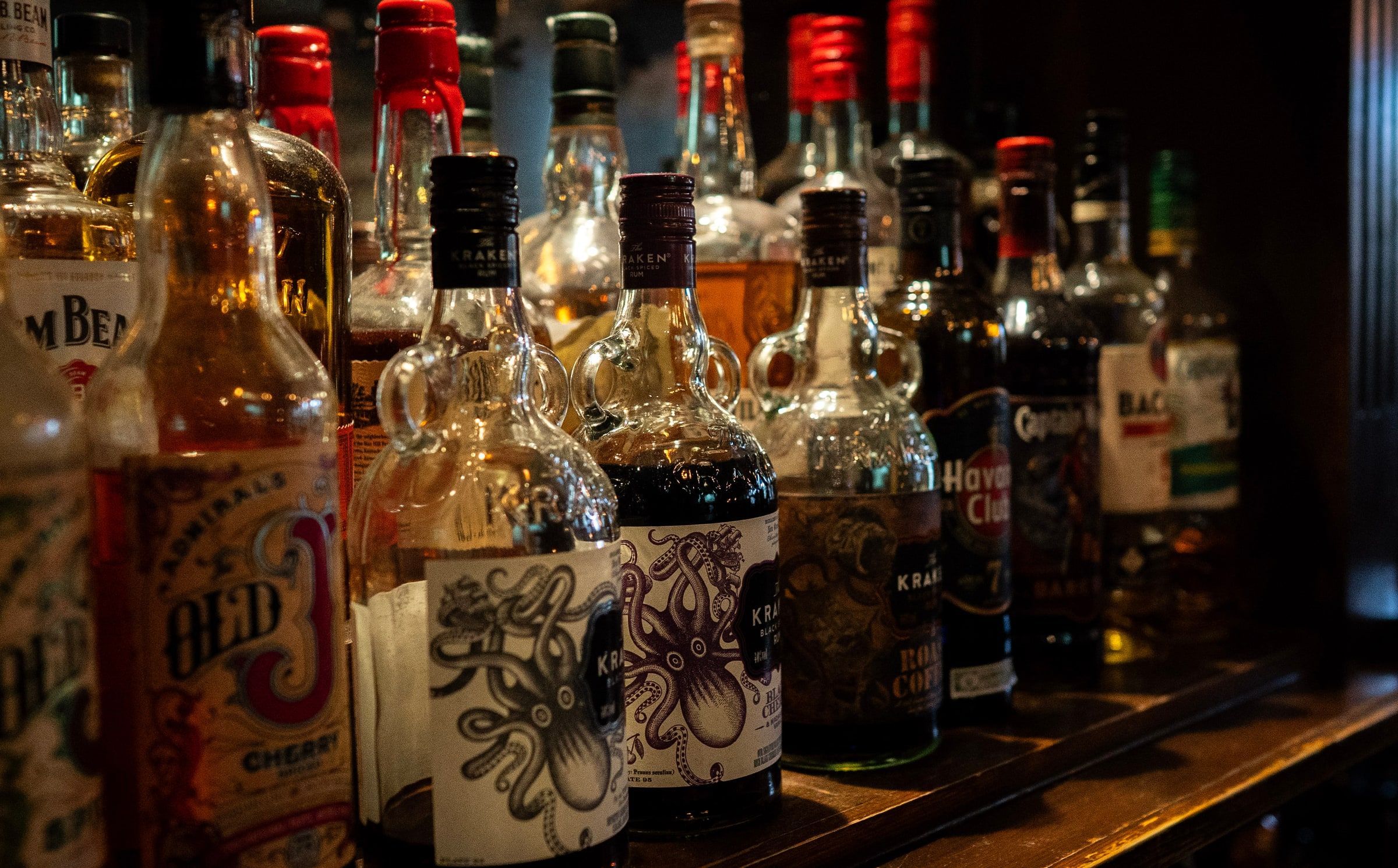 Bottles of rum on the shelf, with Kraken, Havana Club and Old J