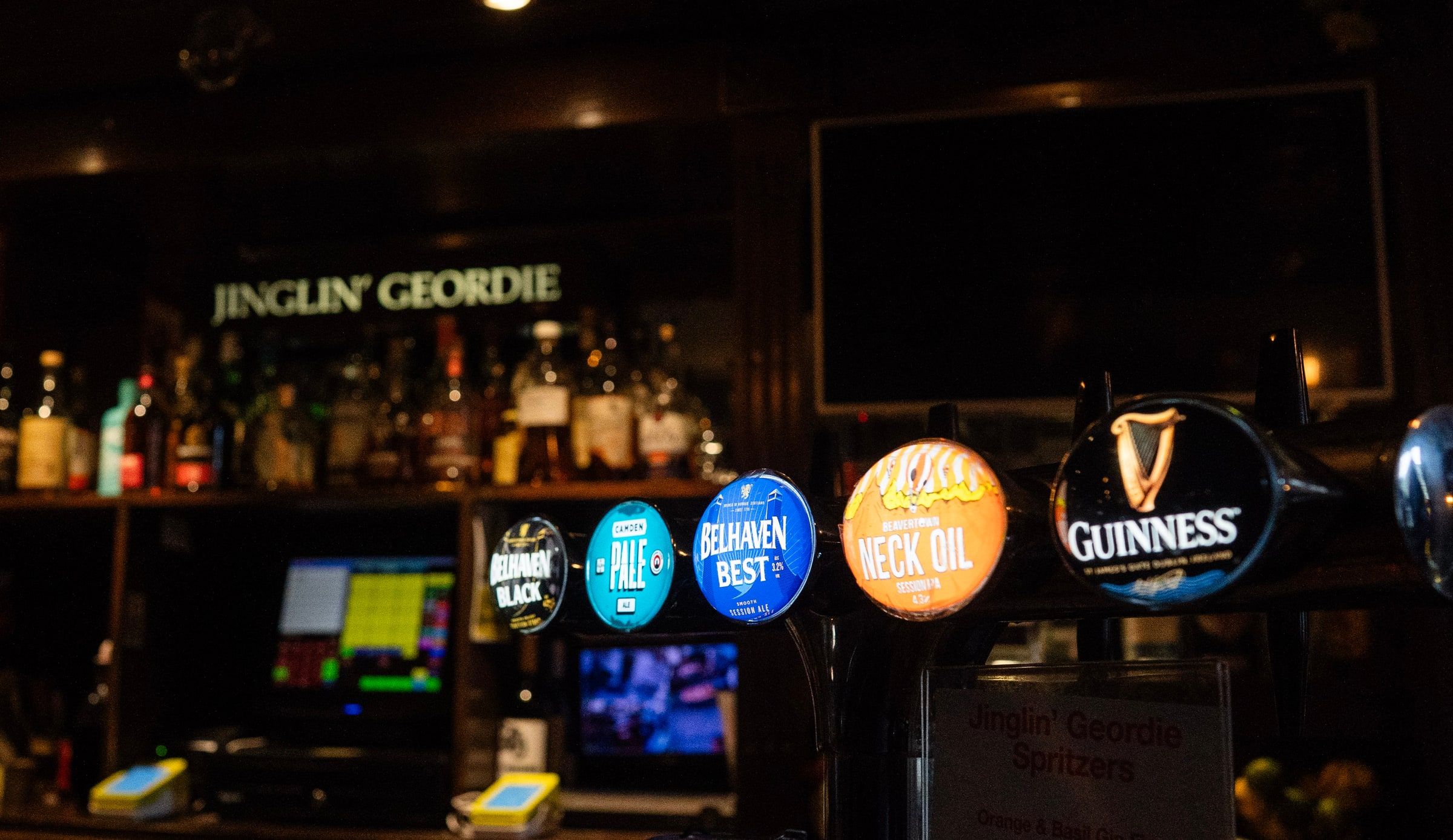 Tap badges for Belhaven Black, Camden Pale, Belhaven Best, Neck Oil and Guinness, with the sign lit behind